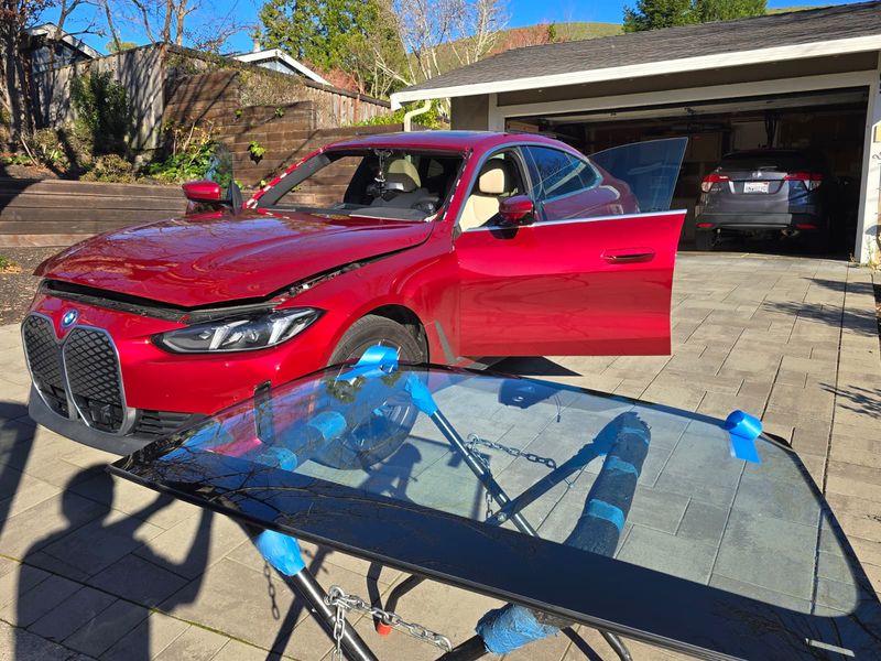 BMW iX windshield on stand ready for installation
